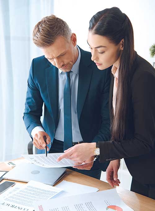 employees discussing something on paper