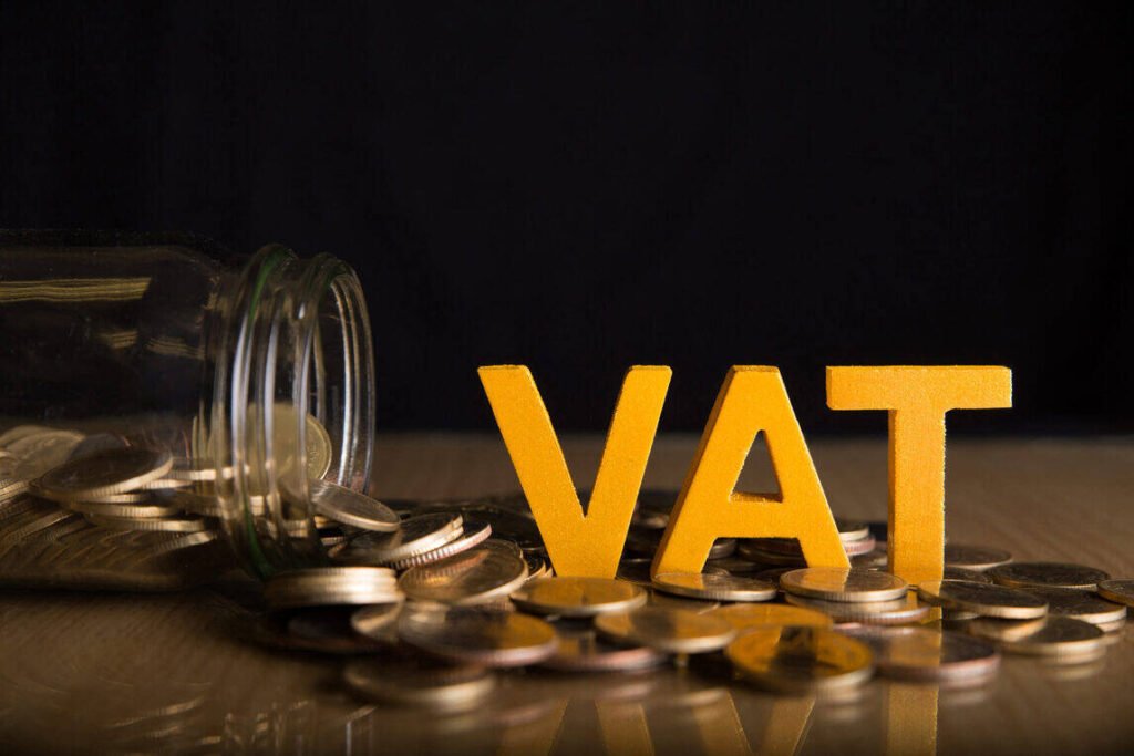 VAT (Value Added Tax) Concept with Currency Coins